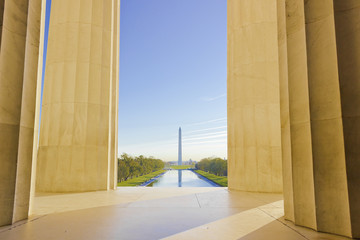 Iconic view of Washington DC's grand tree-lined boulevard, he National Mall from within the Greek Doric temple honouring Abraham Lincoln, the Lincoln Memorial