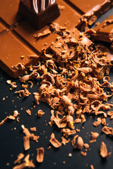 Many candy and chocolate chips on a black background
