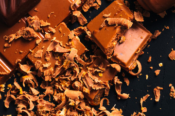 Many candy and chocolate chips on a black background