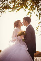 young bride and groom on the background of lake