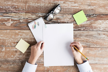 close up of hands with papers and eyeglasses