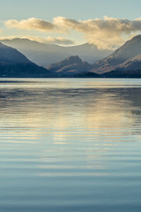 Perfectly calm morning at Derwentwater in the English Lake District with ripples in the water and clouds in sky.
