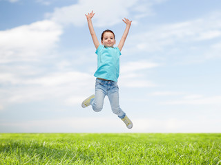 Fototapeta na wymiar happy little girl jumping in air