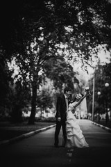 Black white photography beautiful young couple stand on background forest