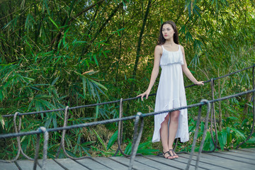 Young woman is relaxing on the hanging bridge