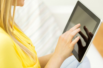 close up of young woman with tablet pc at home