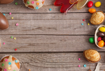 Chocolate Easter Eggs and Cake Over Wooden Background