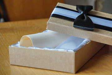 Opened gift box with the voucher certificate inside of the luxurious velvet filling
