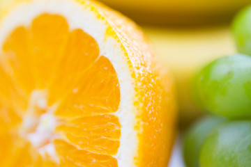 close up of fresh juicy orange and grape