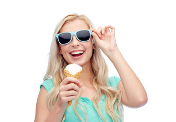 happy young woman in sunglasses eating ice cream