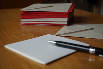 Packet of red and silver (pearly) envelopes prepared for the written announcement note
