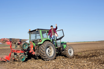 Farmer standing on the tractor