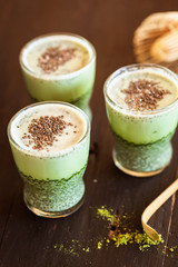 Matcha green tea chia pudding in blac wooden table