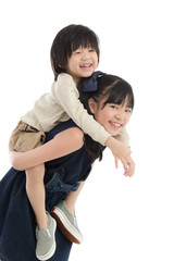  girl giving her brother piggyback ride