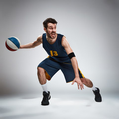 Full length portrait of a basketball player with ball 