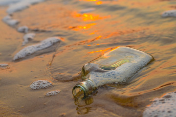bottle on the beach at sunset time