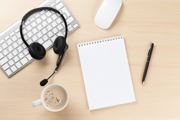 Office desk with headset, notepad and pc