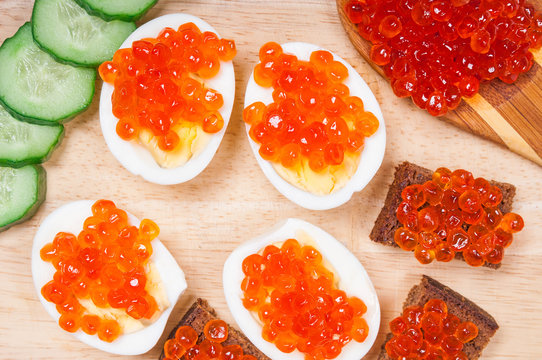 Snacks with red caviar and cucunbers