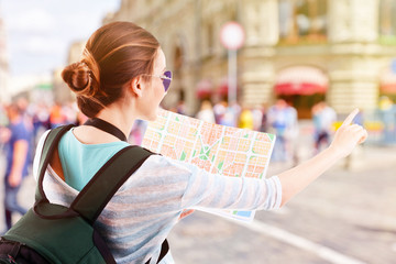 Traveler with map on the street outdoors