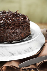Tasty chocolate cake on wooden background