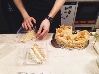 Cake and coffee take away in cafe with barista