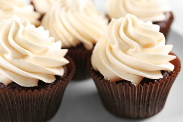 White cupcakes on wooden table