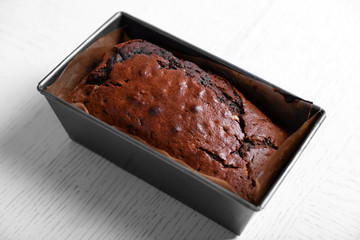 Chocolate cake in baking dish on white table