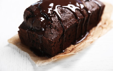 Chocolate cake with icing on white table