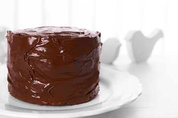 Tasty chocolate cake on light background