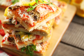 Pieces of delicious pizza on the table, close-up