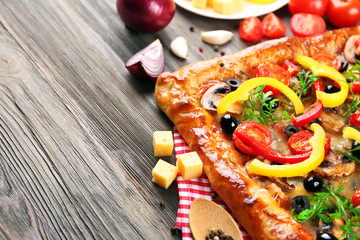 Freshly homemade pizza on wooden background