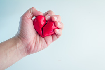 Female hands holding broken heart