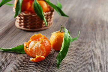 Peeled fresh tangerine on wooden table, closeup