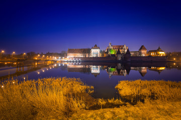 The Castle of the Teutonic Order in Malbork at dusk, Poland