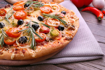 Delicious fresh pizza on wooden table closeup