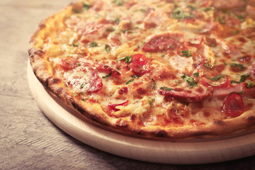 Delicious pizza on wooden table, close up