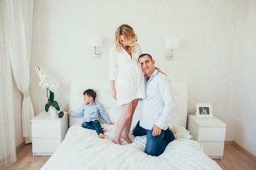 happy family in bedroom.a pregnant woman