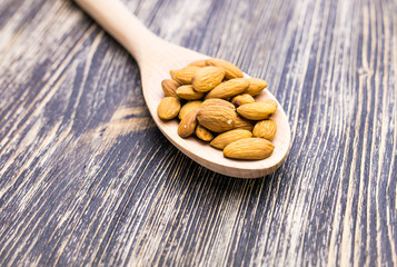 Almonds in wooden spoon 