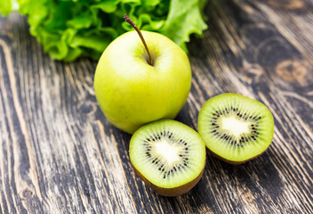 Fresh kiwi and apples   on wooden background. Concept of healthy lifestyle and healthy food....