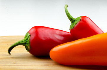 Peppers on the Cutting Board / A mix of colored peppers on the cutting board.
