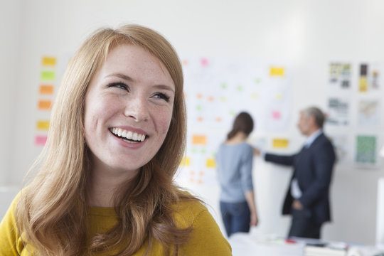 Laughing young woman in office