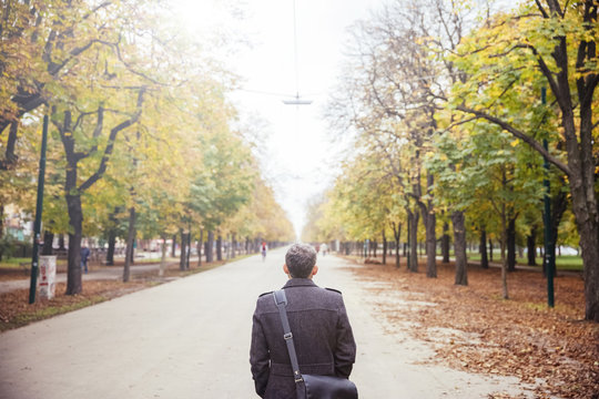 Austria, Vienna, man walking in Prater avenue