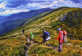 Fototapeta na wymiar Group of hikers in the mountains, view of Carpathian mountains