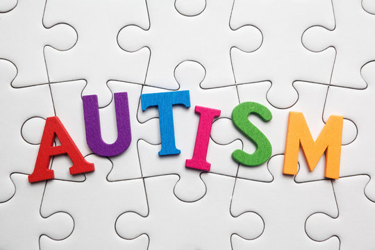 Autism inscription on a white puzzle background