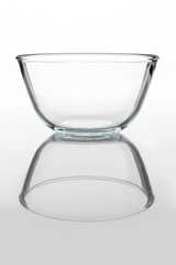 Glass transparent bowl on white background from side with reflection vertical composition © ksu_bu