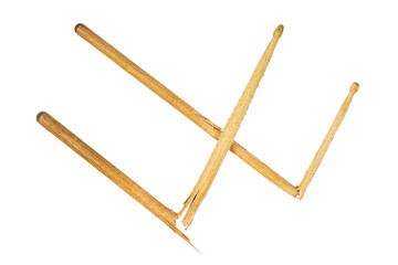Two broken wooden drumsticks isolated on white