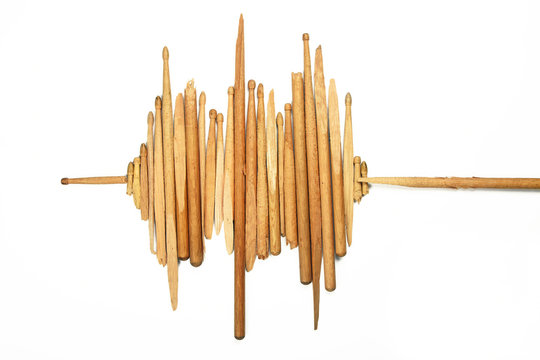 Sound wave of broken wooden drumsticks on white