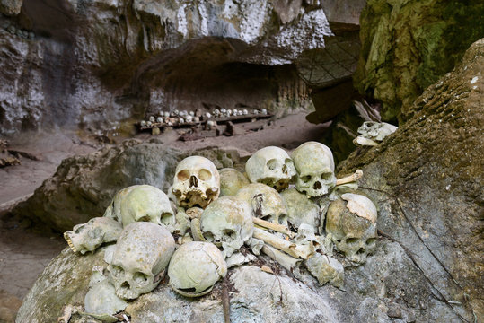 Pile of skulls by the entrance to TampangAllo burial cave in Tana Toraja. Indonesia
