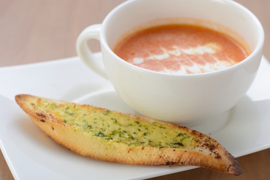 Tomato and carrot soup serve with garlic bread
