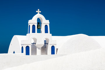 A white church with blue elements in Oia on Santorini island, Greece.